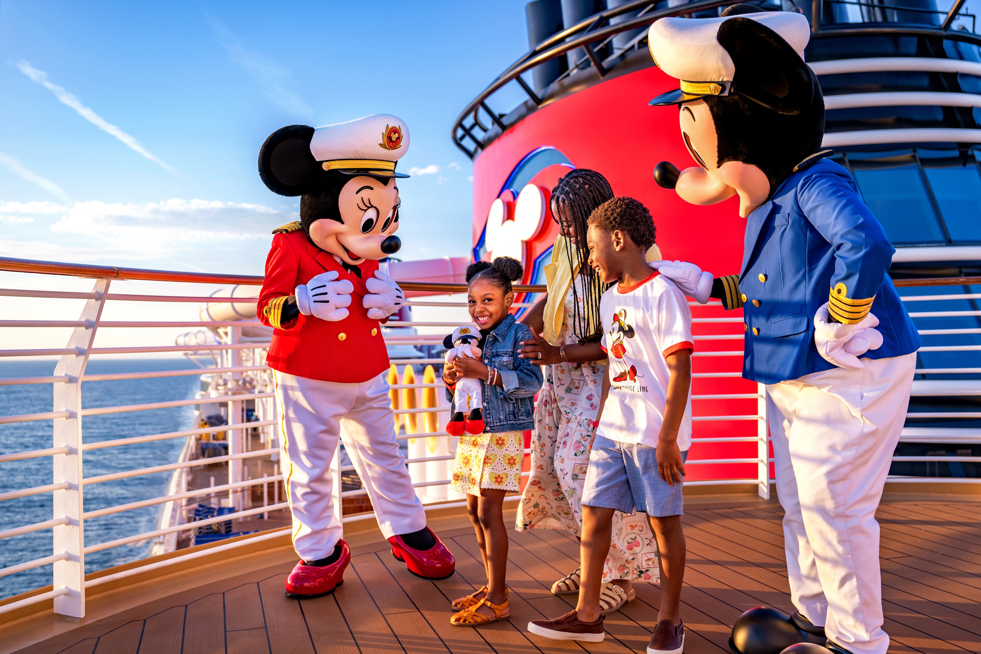 Une famille de 3 rencontrent Mickey Mouse et Capitaine Minnie Mouse sur une croisière de la Disney Cruise Line.